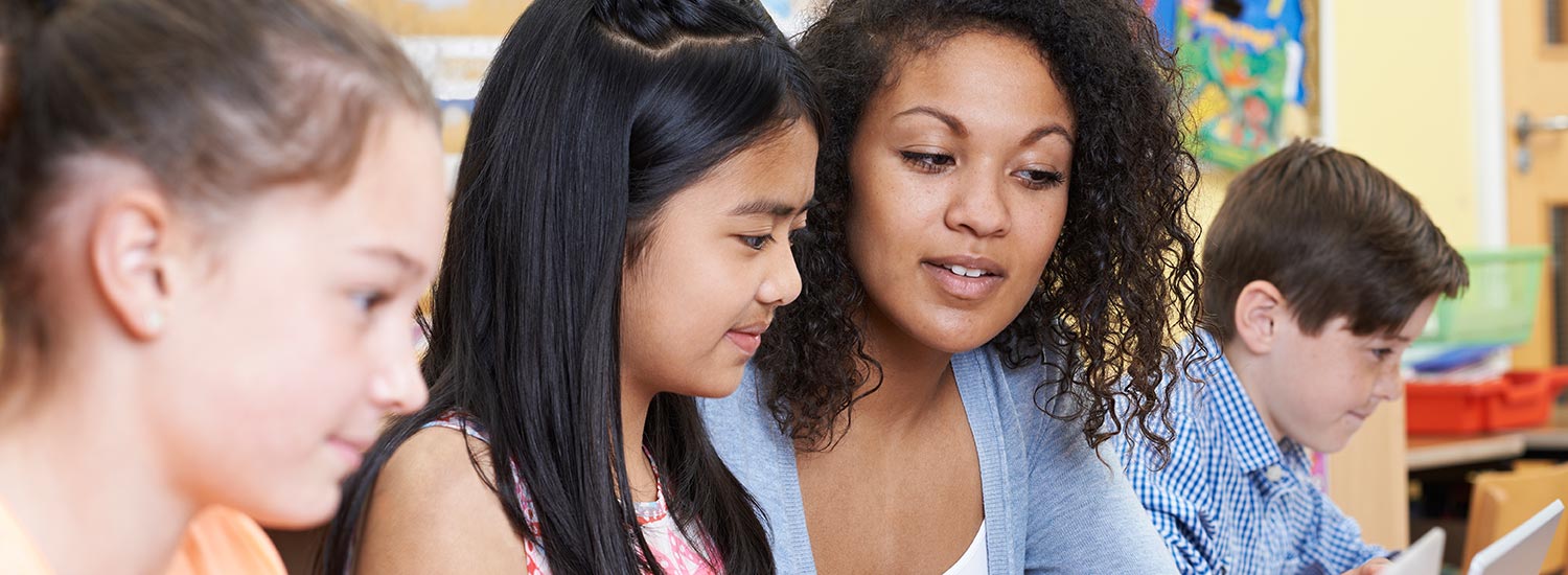 Teacher Encouraging Student in a Small Classroom Setting